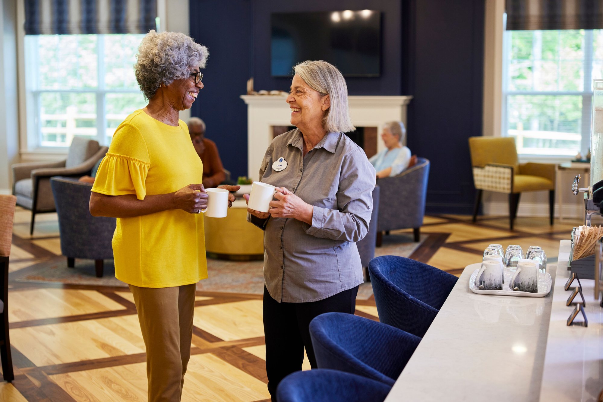 Arbor Director talking with woman holding coffee