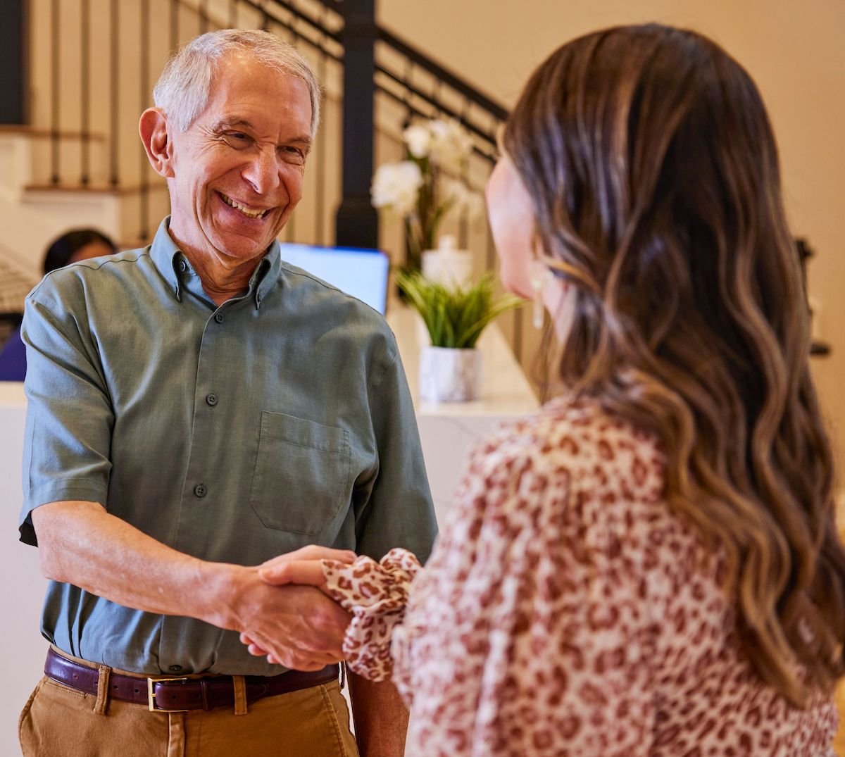 Team member shaking hands with resident - crop
