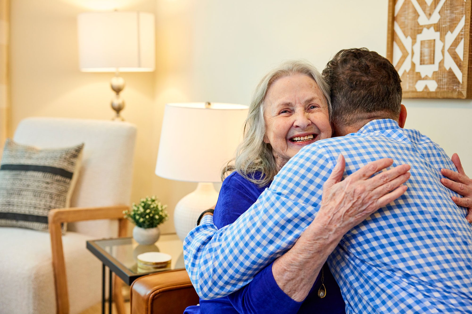Senior resident hugging a member of the maintenance department